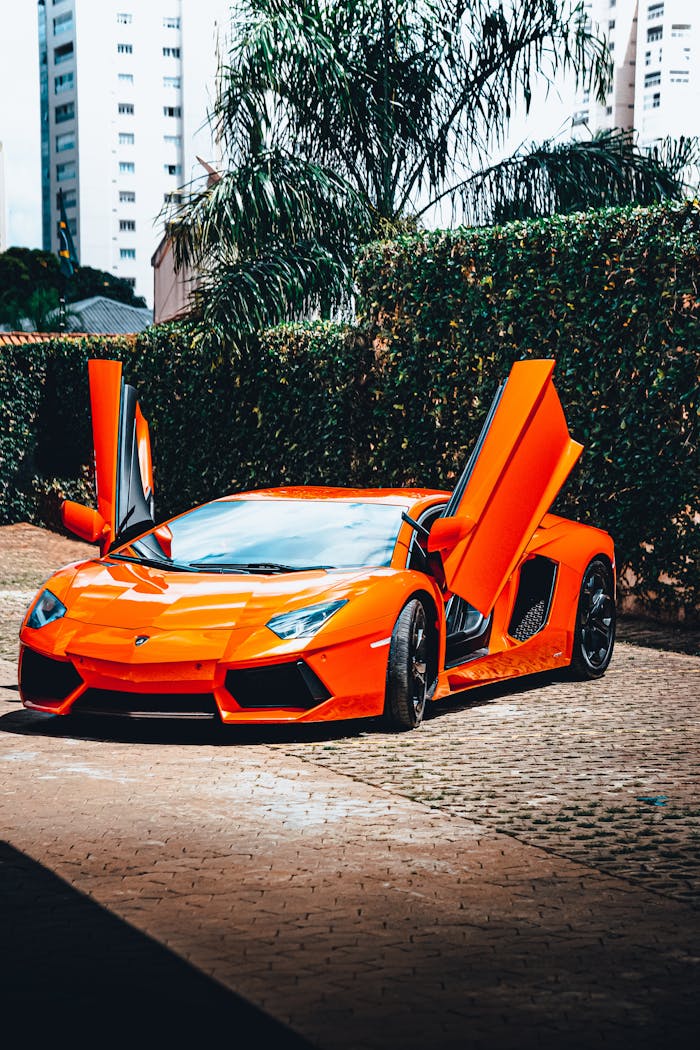 services-img Orange sports car with open doors in a cityscape, showcasing luxury and speed.
