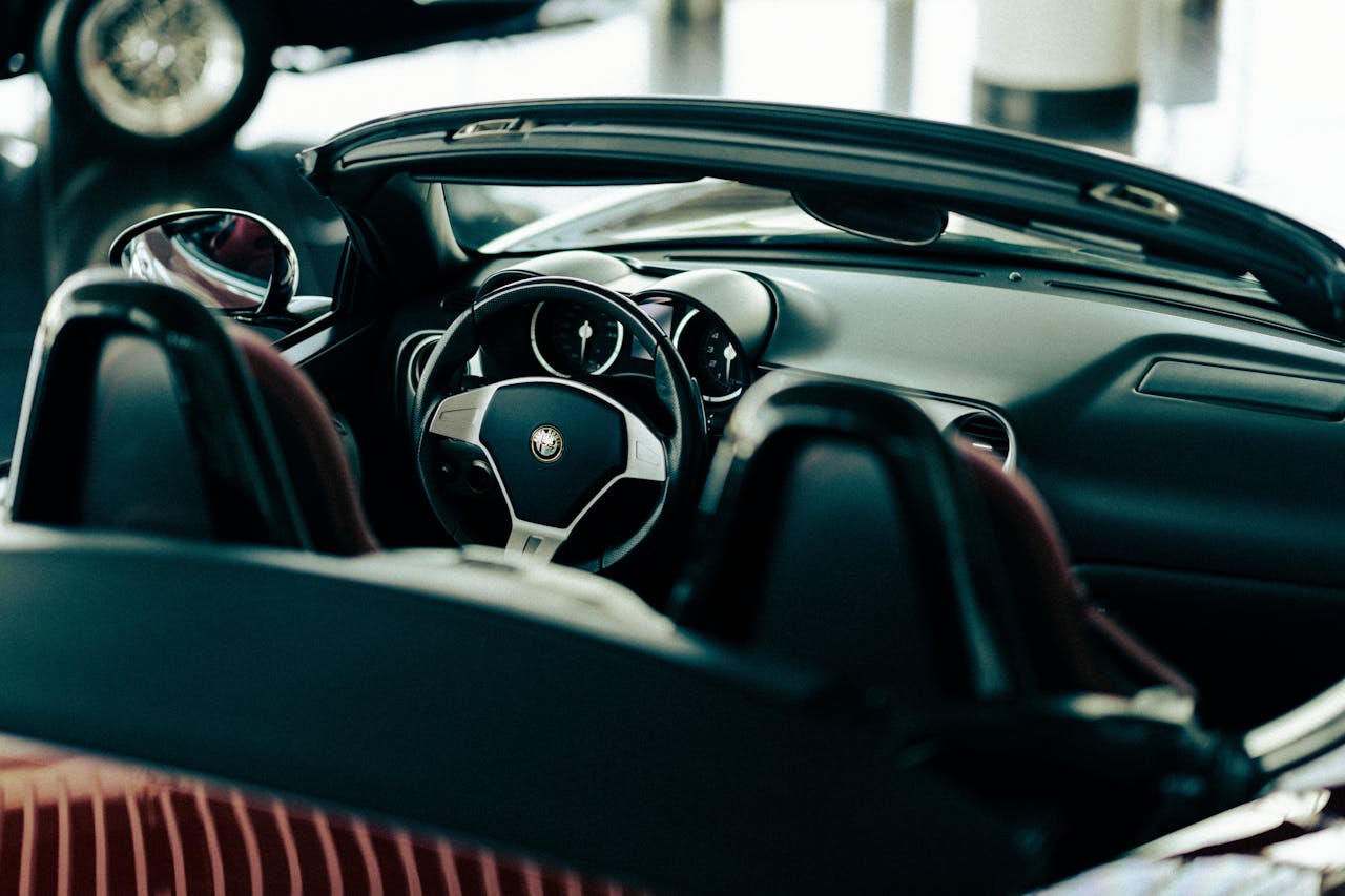 services-02 Close-up of a luxury convertible car interior, showcasing sleek design and modern dashboard.